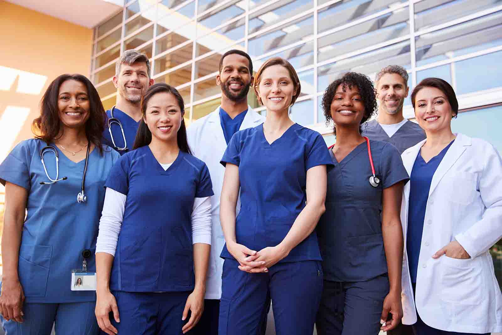 A group of nurses standing together smiling