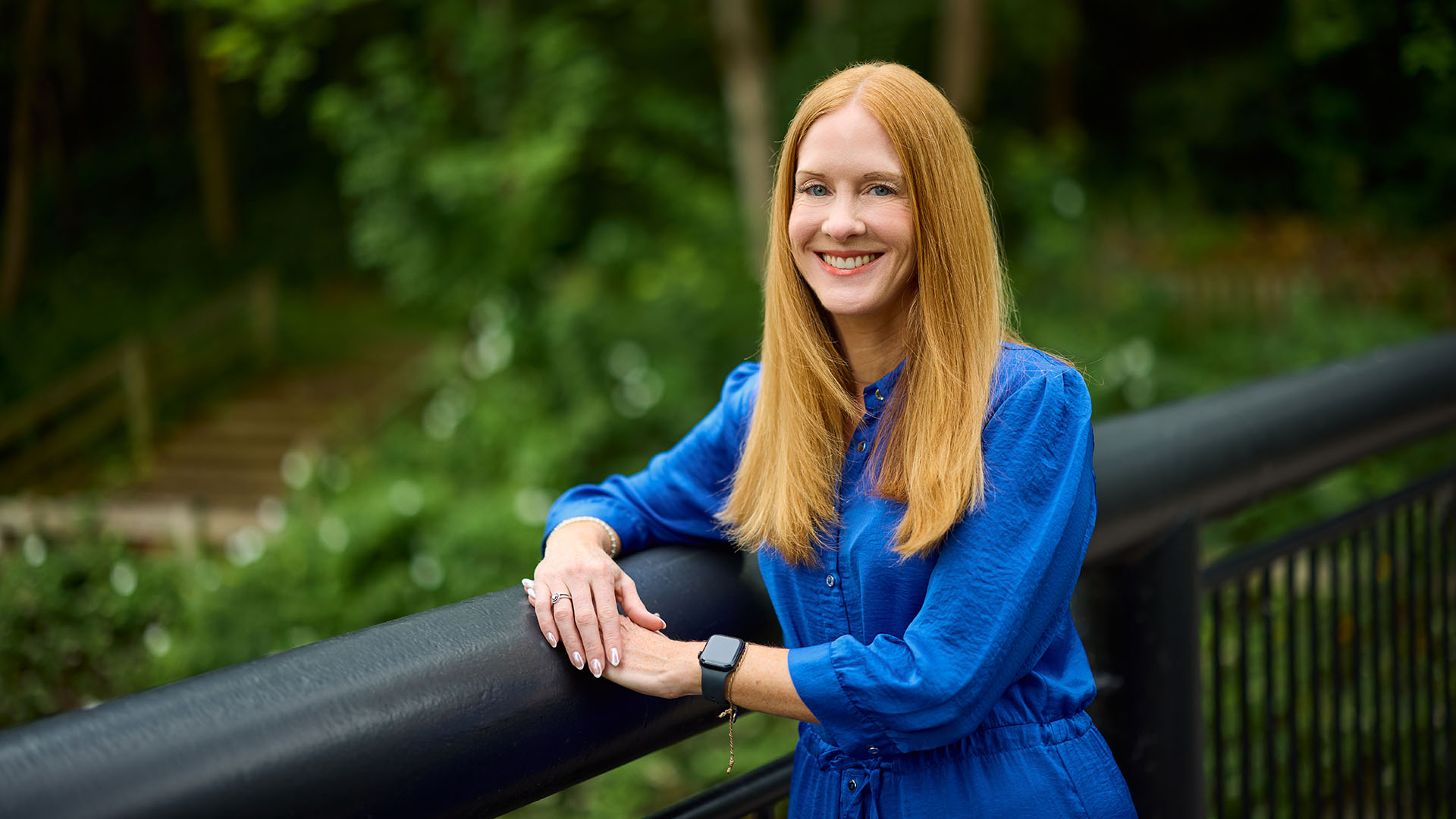 A headshot of Claire Aydogan, who is stood outdoors