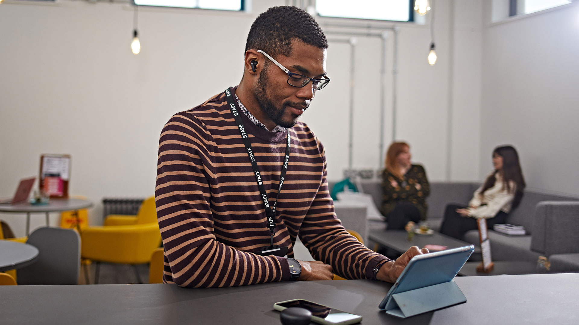 A student studying on a tablet.