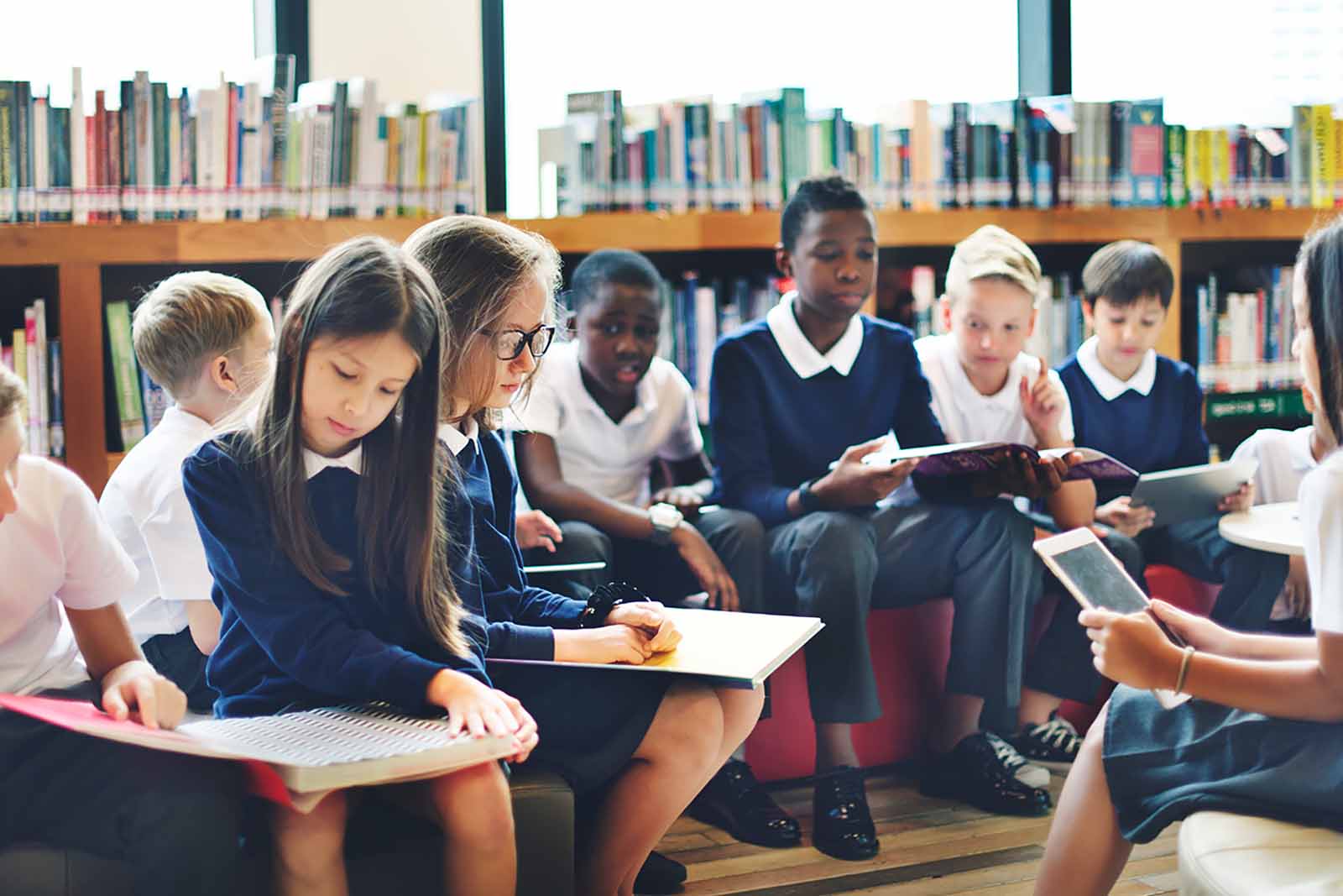 A diverse group of schoolchildren in a library