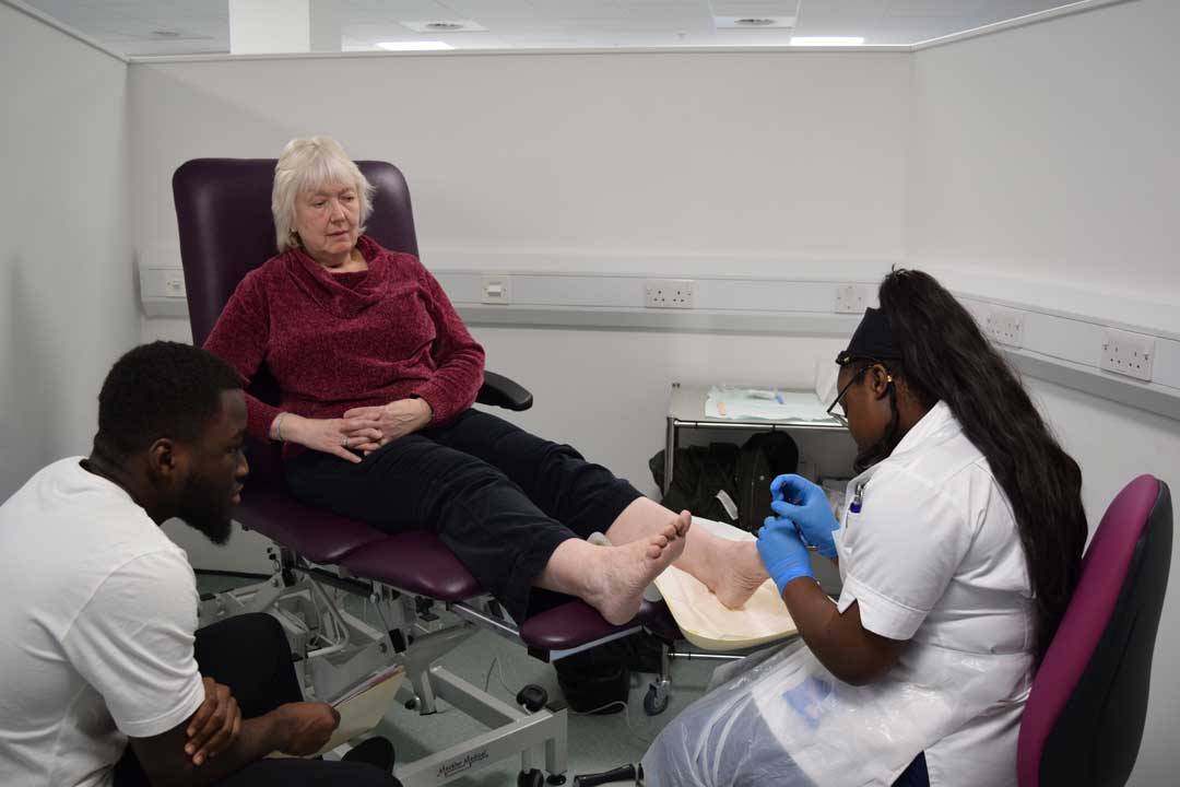 Collaborative learning in action—podiatry and pharmacy students working together to support patient care.
